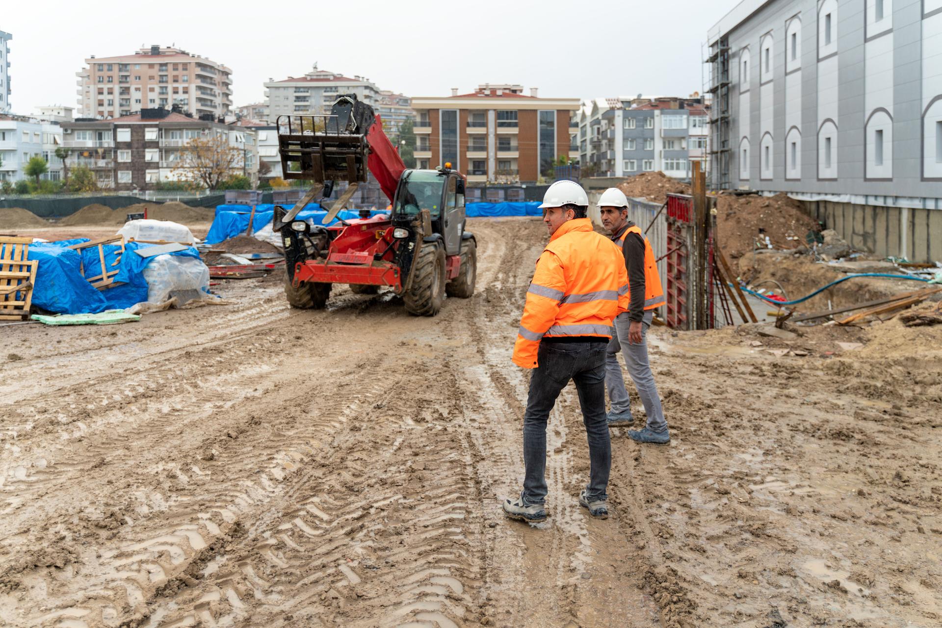 Engineer and foreman examining construction site outdoors