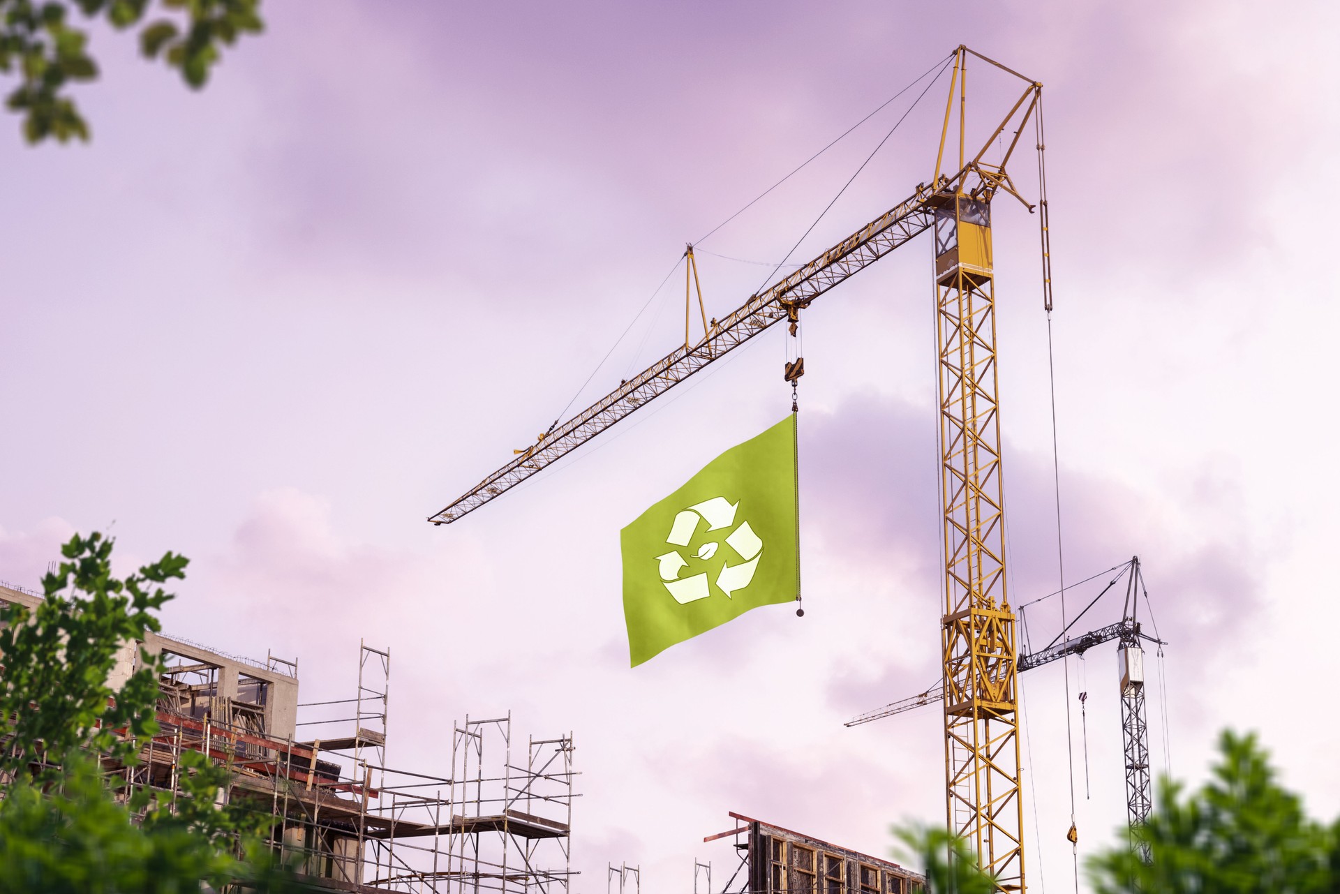 Construction site with a crane hoisting a green flag