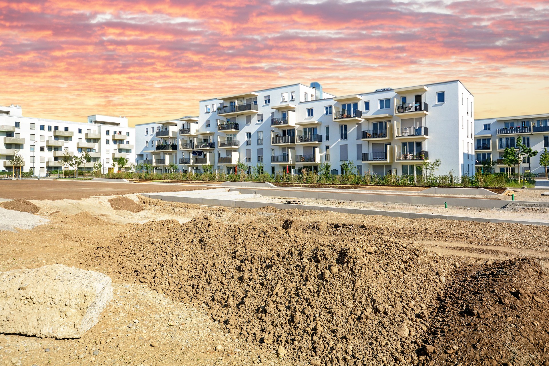 New urban development with construction site and modern residential buildings